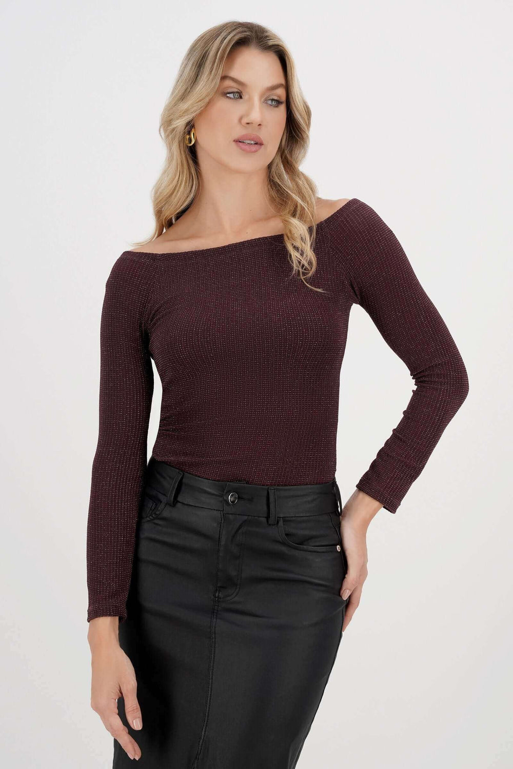 Mujer con blusa de manga larga marrón y falda negra en la colección Eva Castillo.